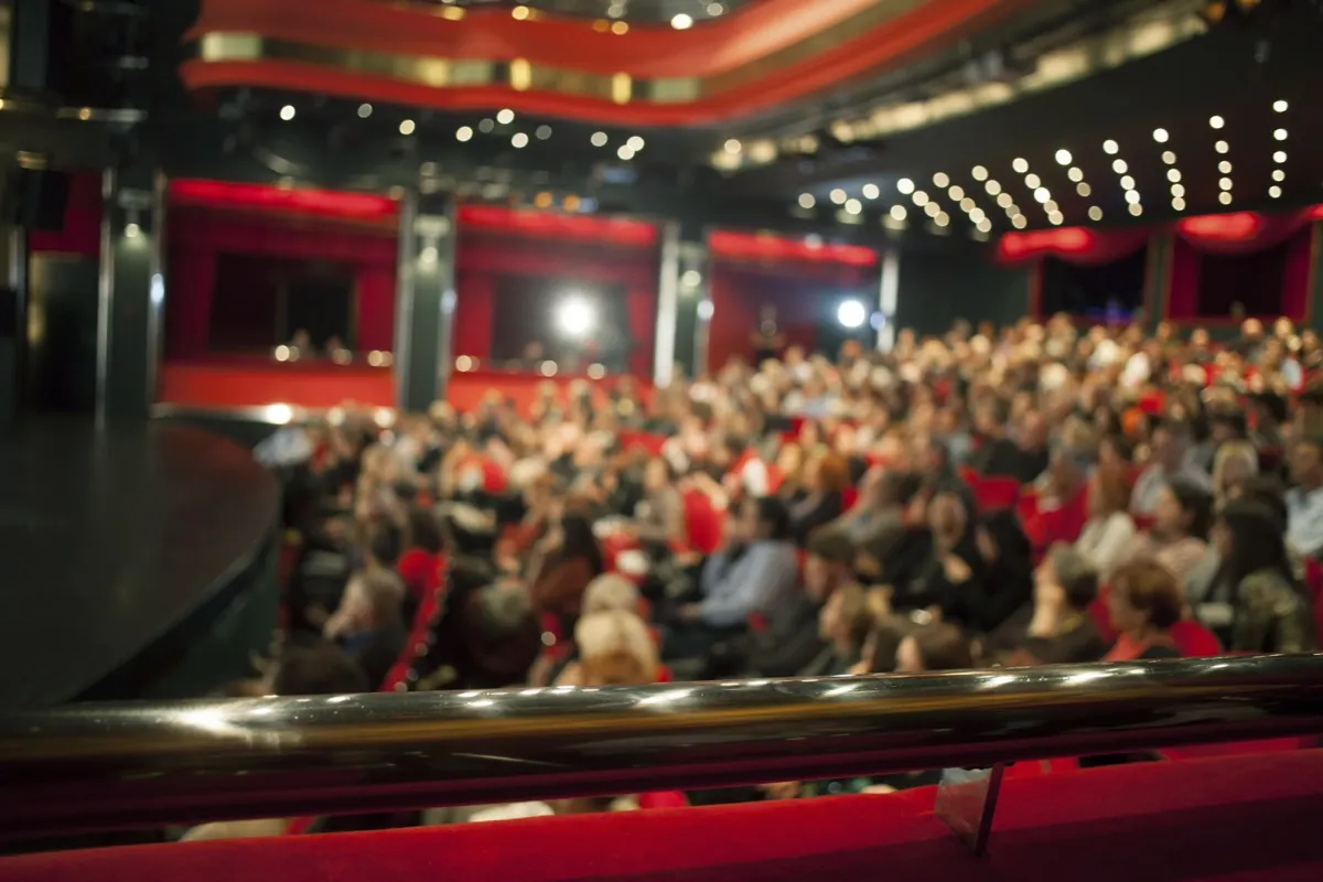 Audience seated in a theatre auditorium before a show