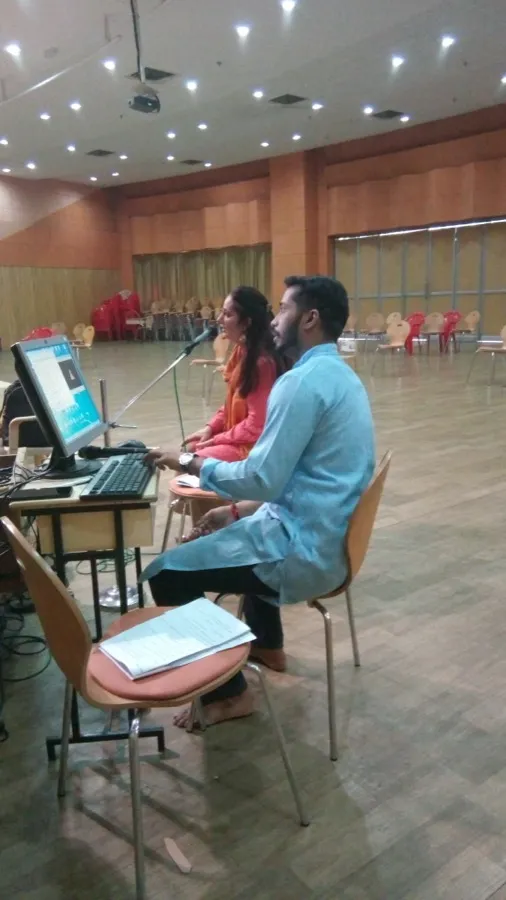 Facilitators at the sound console during a session in a large hall